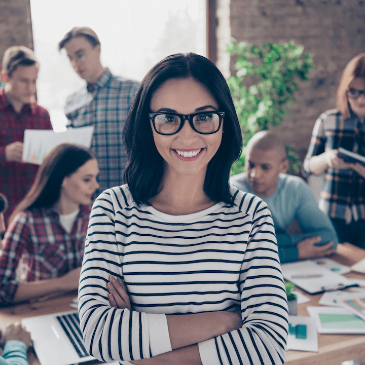 A confident founder standing in front of her team
